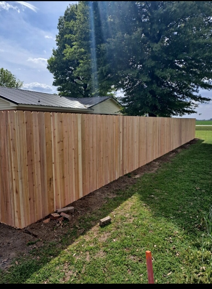 Long run of freshly installed wood privacy fencing