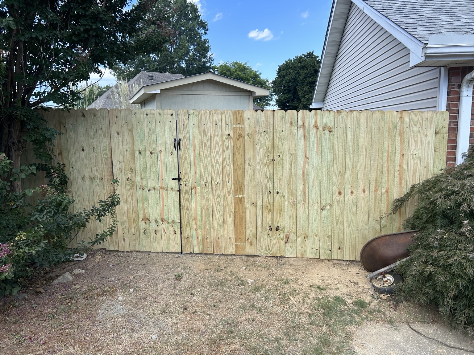 Wood privacy fence with framed walk gate